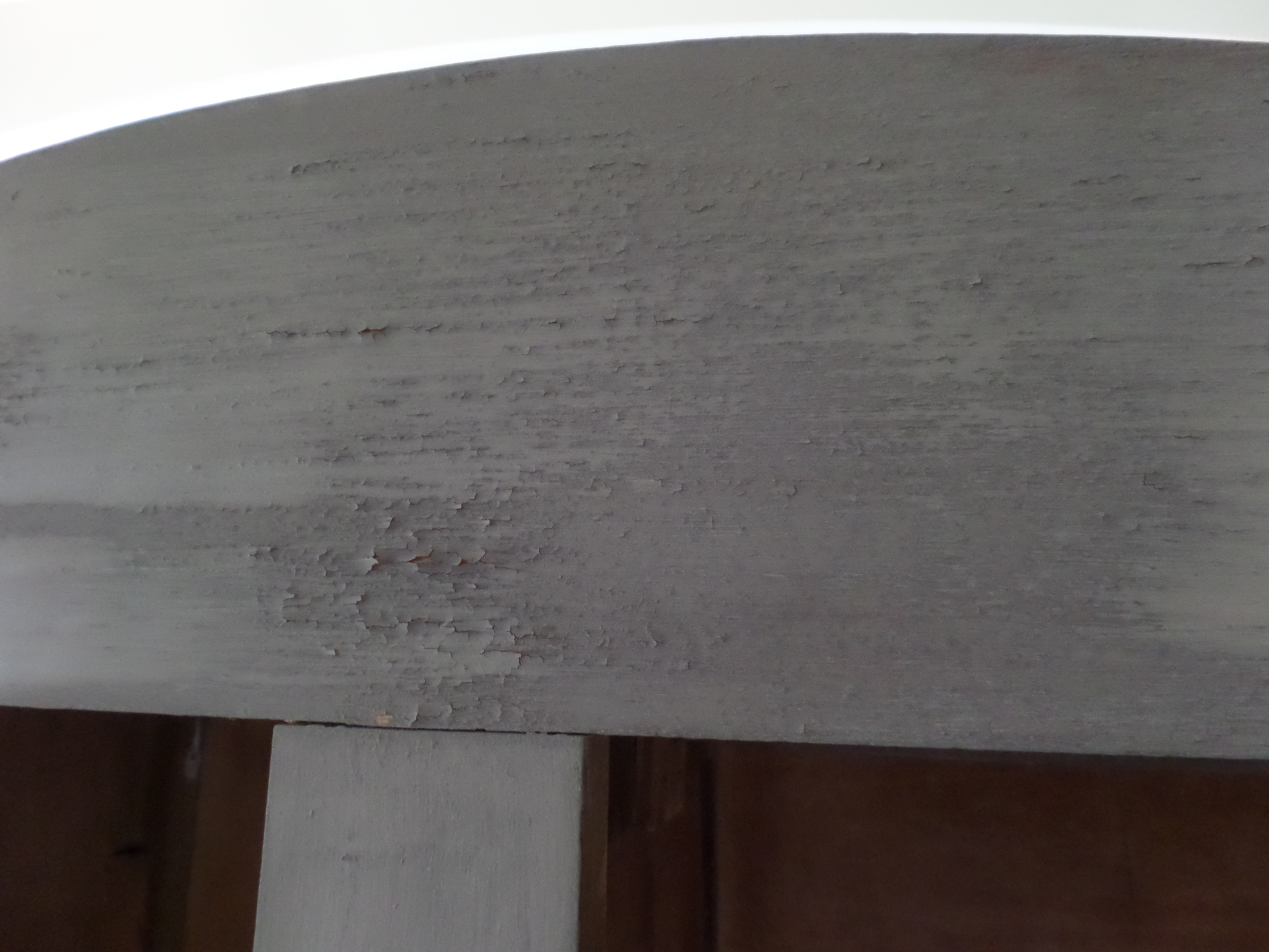 Flaky gray paint on chiffarobe.