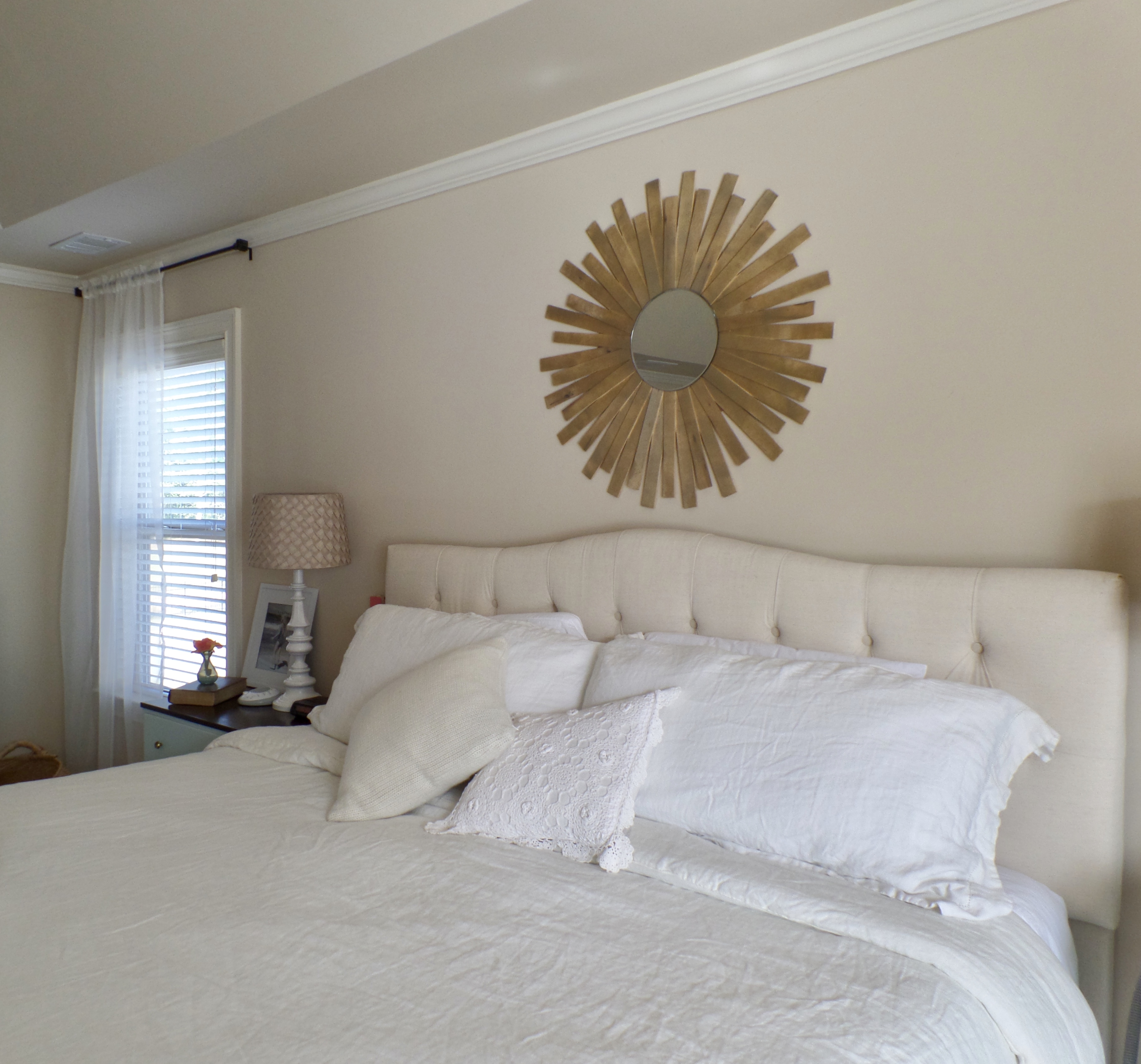 Outdated furniture and decor in a master bedroom before a makeover.