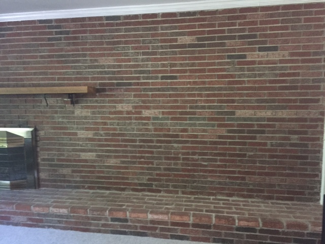 A large brick fireplace and hearth.