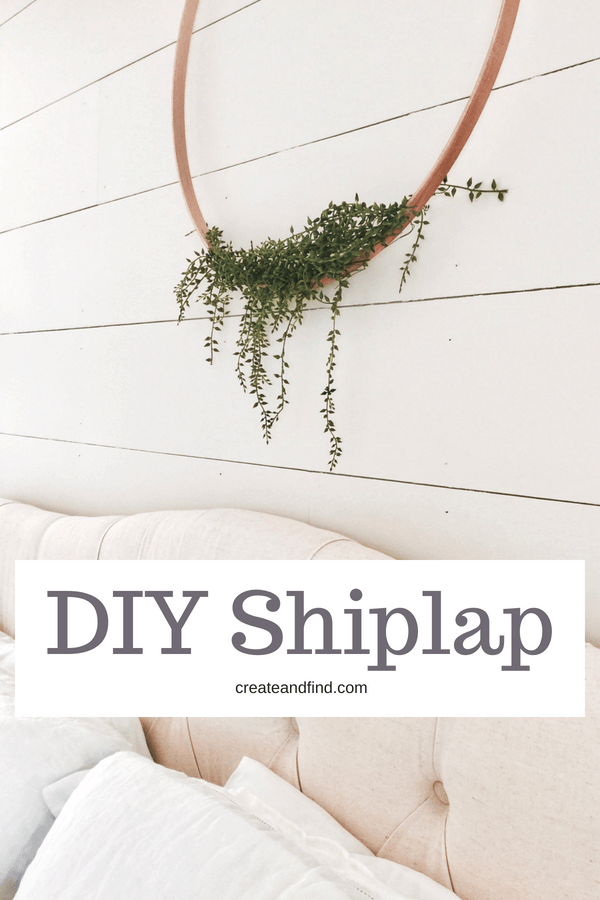 Pinterest graphic with text that reads \"DIY Shiplap\" and a white shiplap wall in the background with a tufted headboard and a floral hoop wreath hanging above.