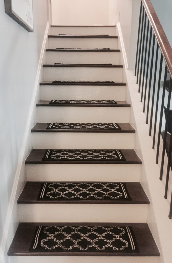 Homemade stair runners from black rugs.