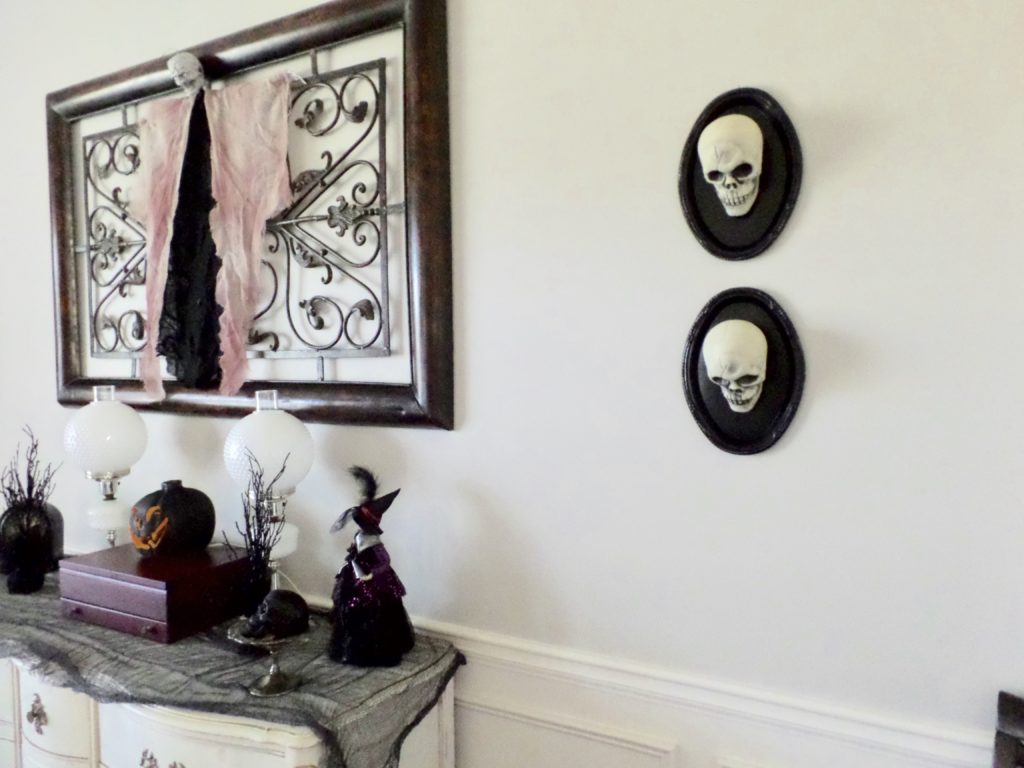 Halloween skulls are mounted on the wall for decorations.