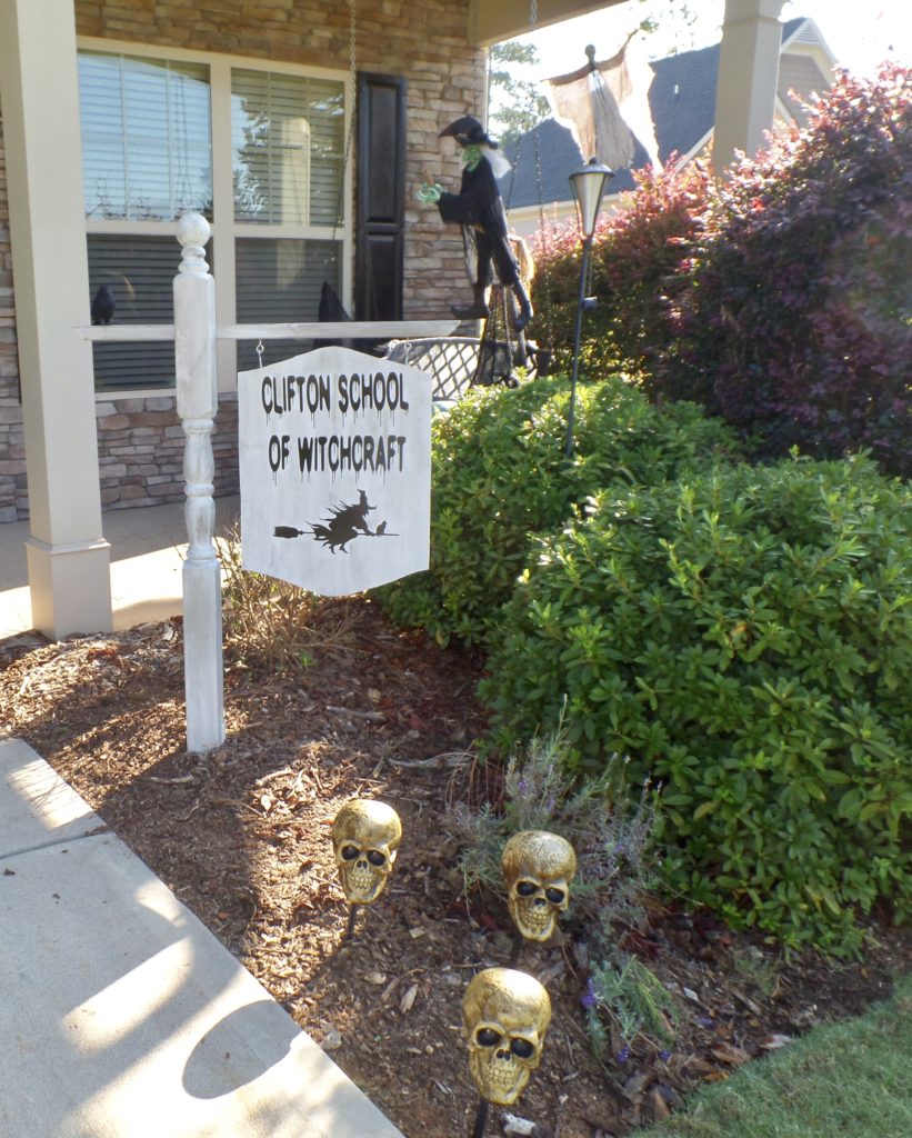 A Halloween sign in front of a house for the \'Clifton School of Witchcraft\'.