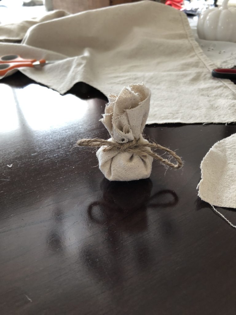 Burlap cloth tied into a gift bag with twine.