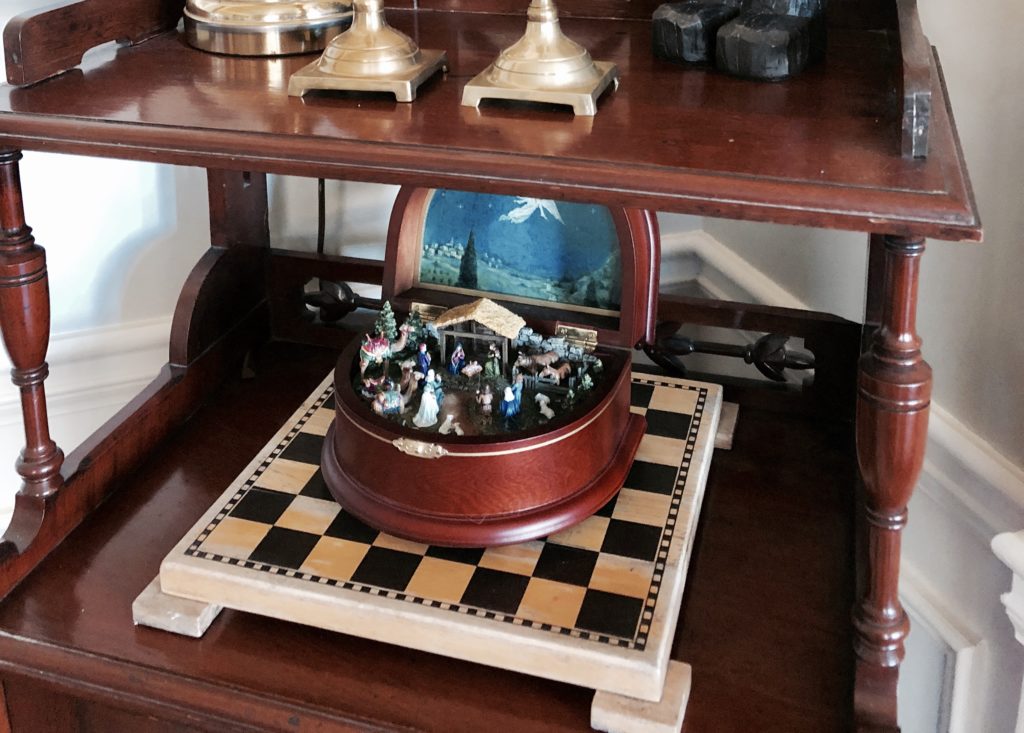 A nativity music box on a chess board.