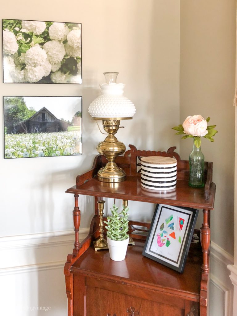 Spring decor on an antique wooden side table in the corner of a room.