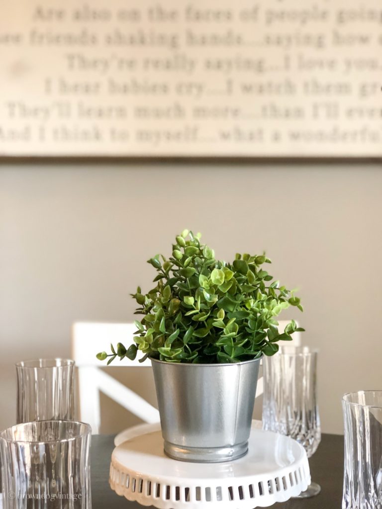 Faux greenery in a metal bucket for Spring decor