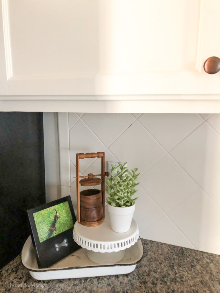 Close-up of painted white tile backsplash in a kitchen.