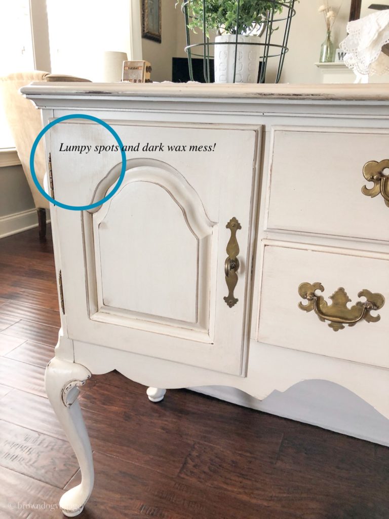 Vintage buffet with a spot circled with a blue circle and text overlay that reads \"Lumpy spots and dark wax mess!\".