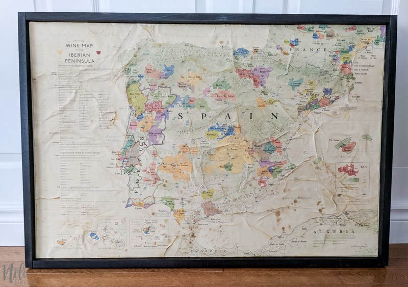 A vintage map of Spain in a rustic wooden frame.