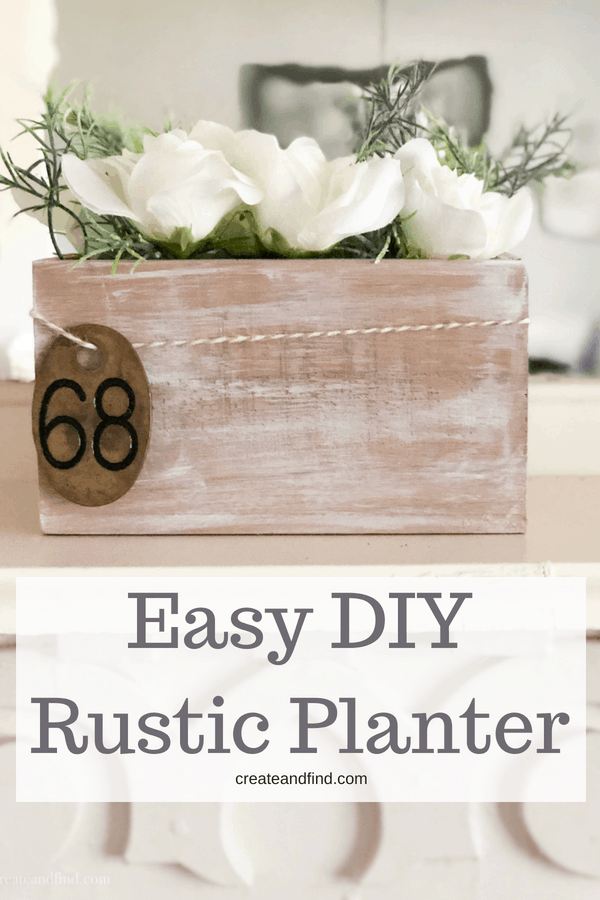 Pinterest graphic with text that reads "Easy DIY Rustic Planter" and white flowers in a whitewashed wooden box.