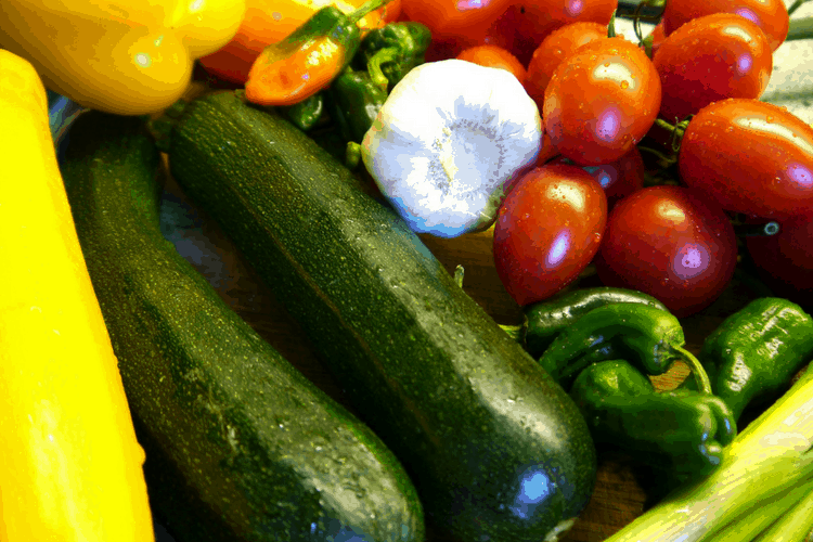 Fresh produce including zucchini, garlic, and tomatoes.