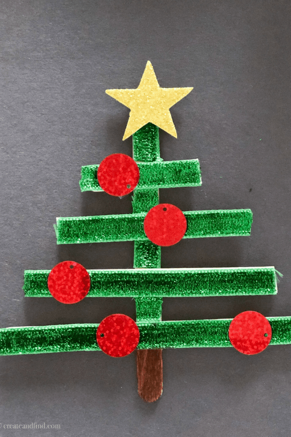 Green stick Christmas tree craft with read ornaments and a gold star.