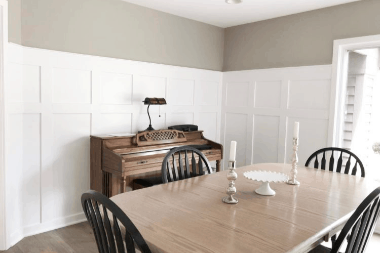 White board and batten accent wall treatment in a dining room with a piano.