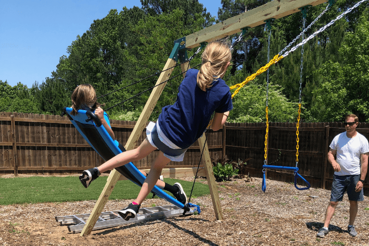 Kids swinging on homemade swing set