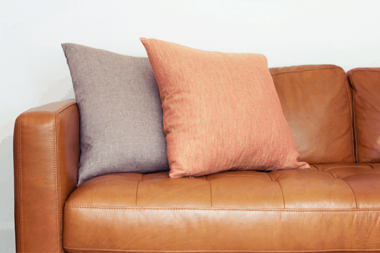 Closeup of throw pillows on a leather couch