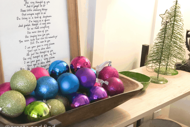 Colorful Christmas ornaments in a wooden bowl