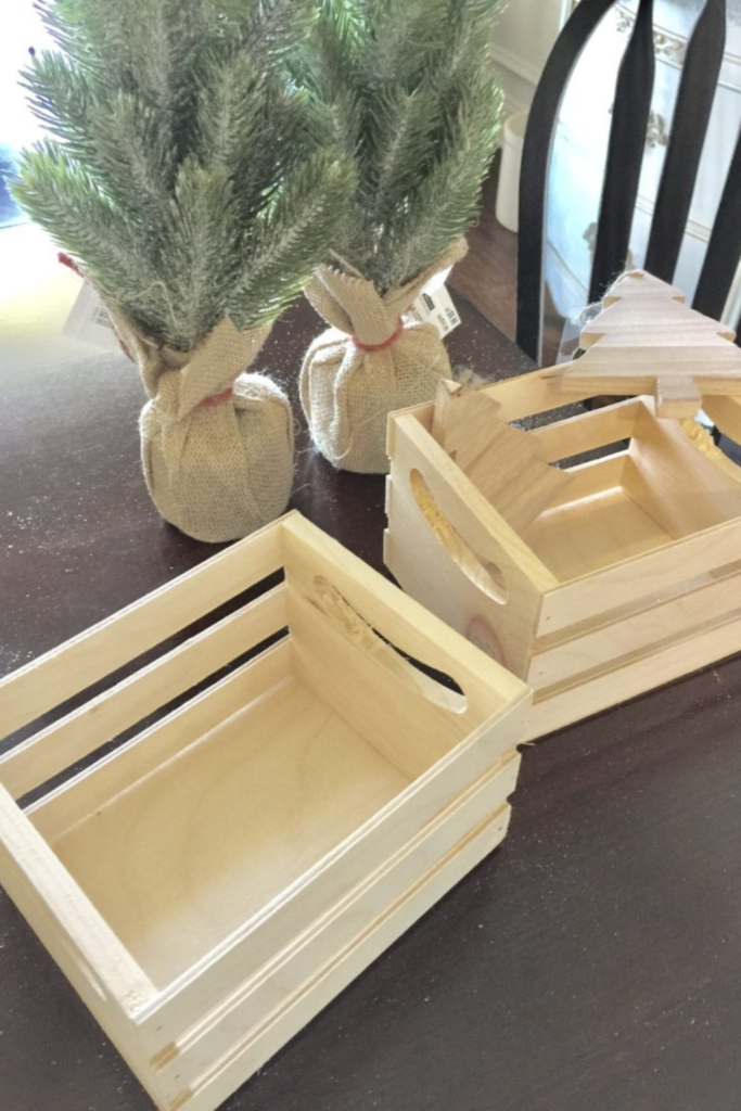 Plain wooden crates and two mini trees in burlap sacks.