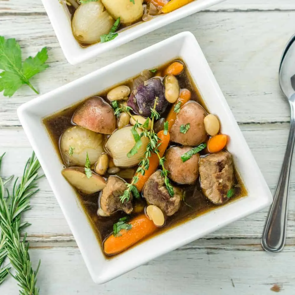 A bowl of Irish beef stew with carrots and potatoes.