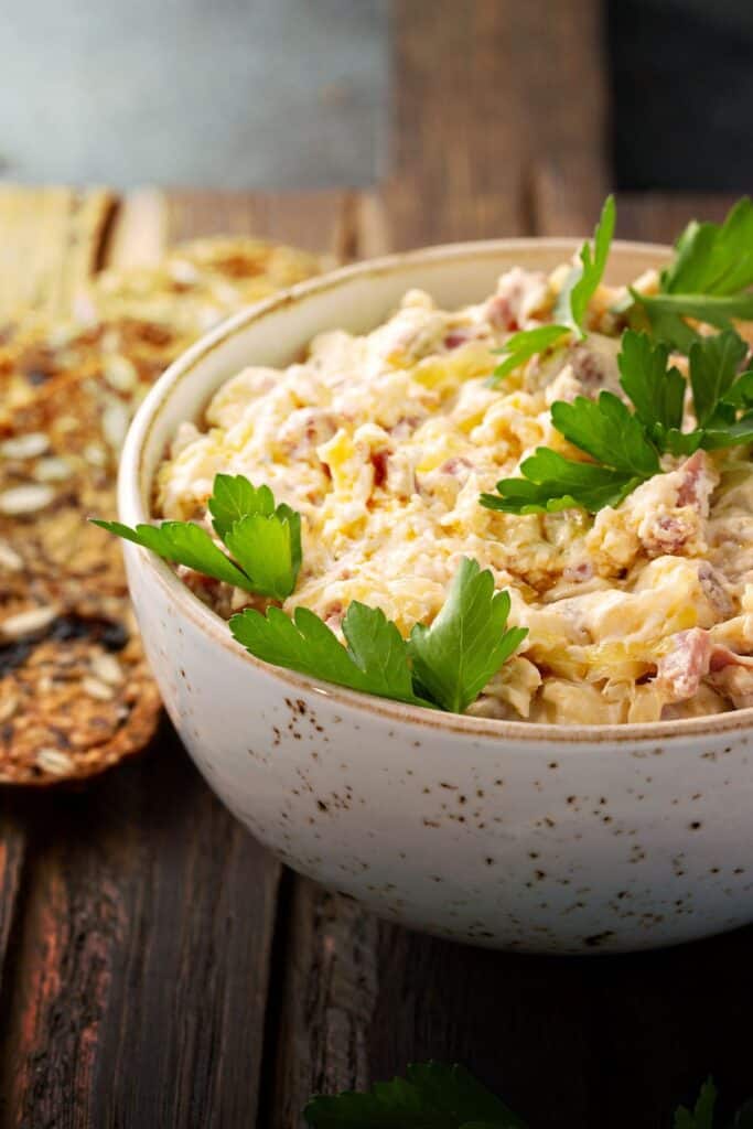 Reuben party dip in a bowl next to crackers.