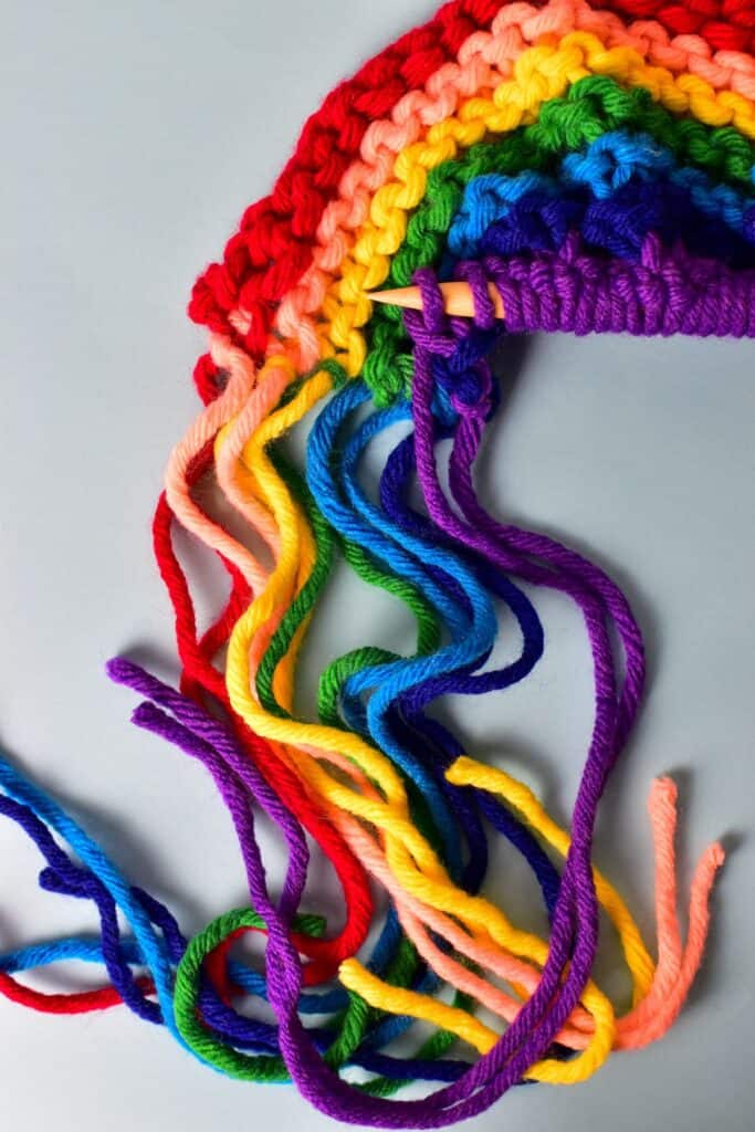 Yarn knit rainbow craft on a white background.