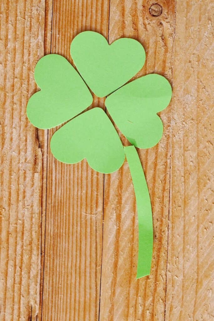 A four leaf clover made from green paper hearts.