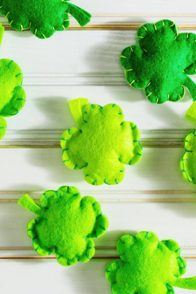 Mini shamrock puff pillows on a wood surface.