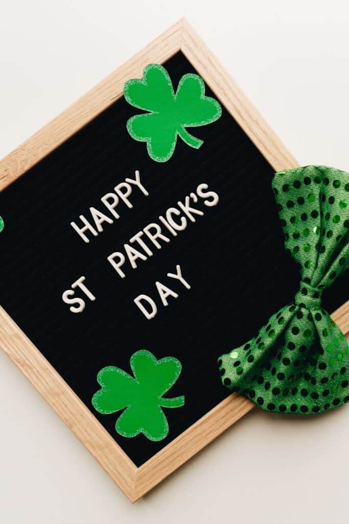 A letterboard that says "Happy St. Patrick's Day" with a green bow tie and shamrocks.