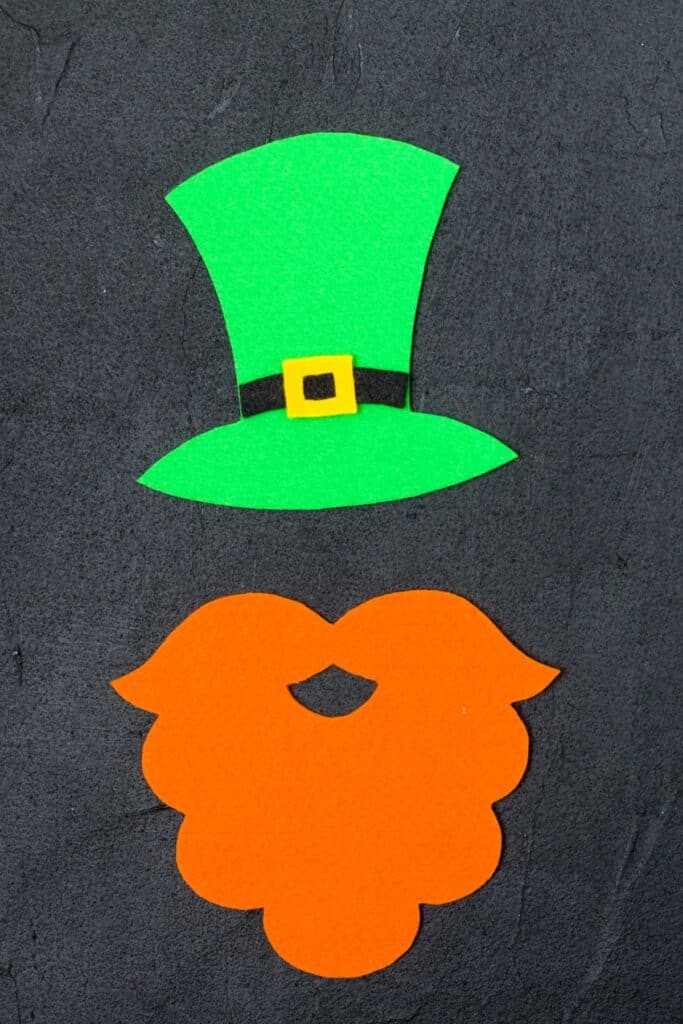 A felt leprechaun at and orange mustache cutouts.