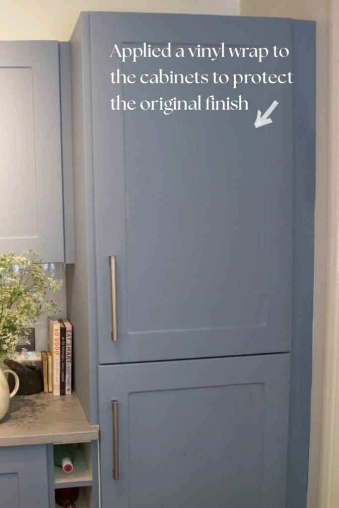 Closeup of a cabinet wrapped in vinyl and painted blue.