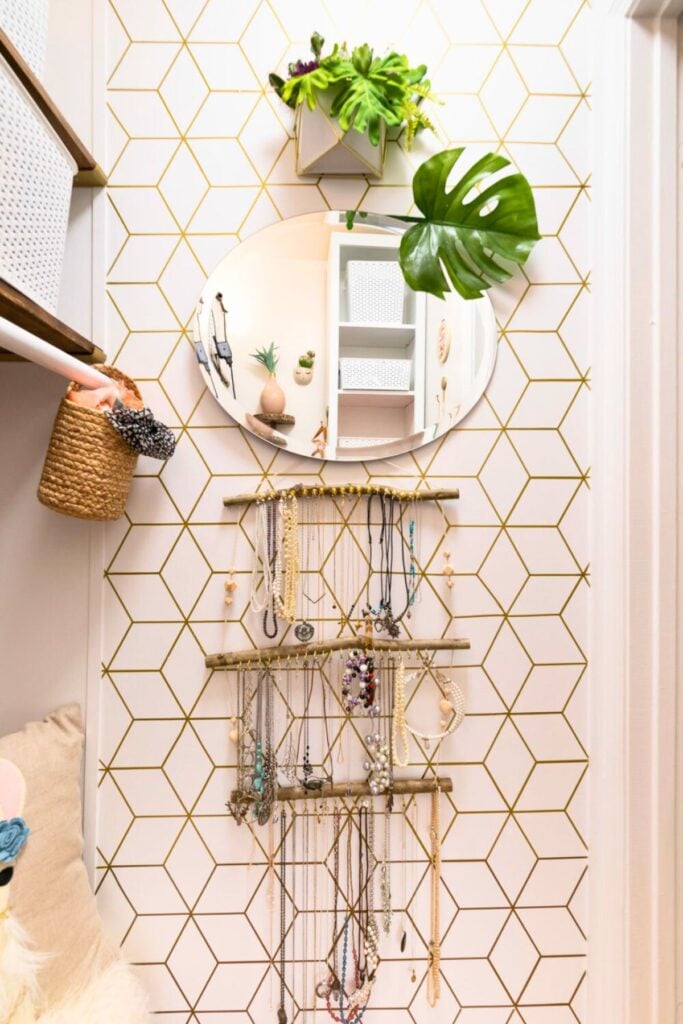 Gold geometric wall pattern painted on a bathroom wall.