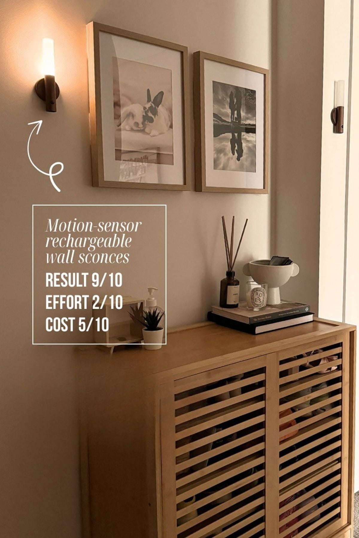 An adhesive wall sconce in a hallway next to a side table and wall decor.