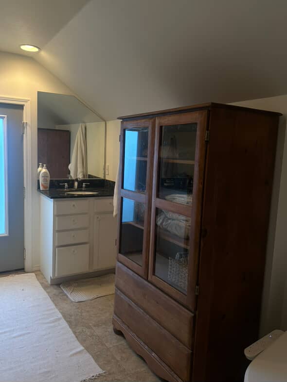 An old outdated bathroom with a sloped ceiling.