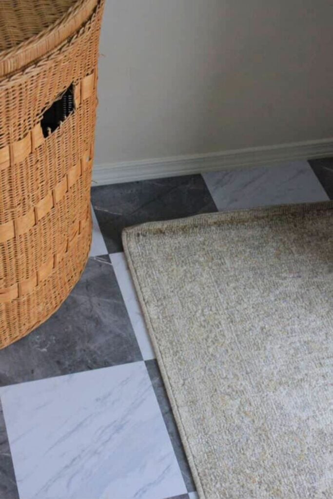 Checkered gray and white "marble" peel and stick tile in a bathroom.