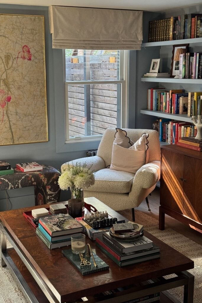 A cozy room with teal paint and colorful layered vintage decor.