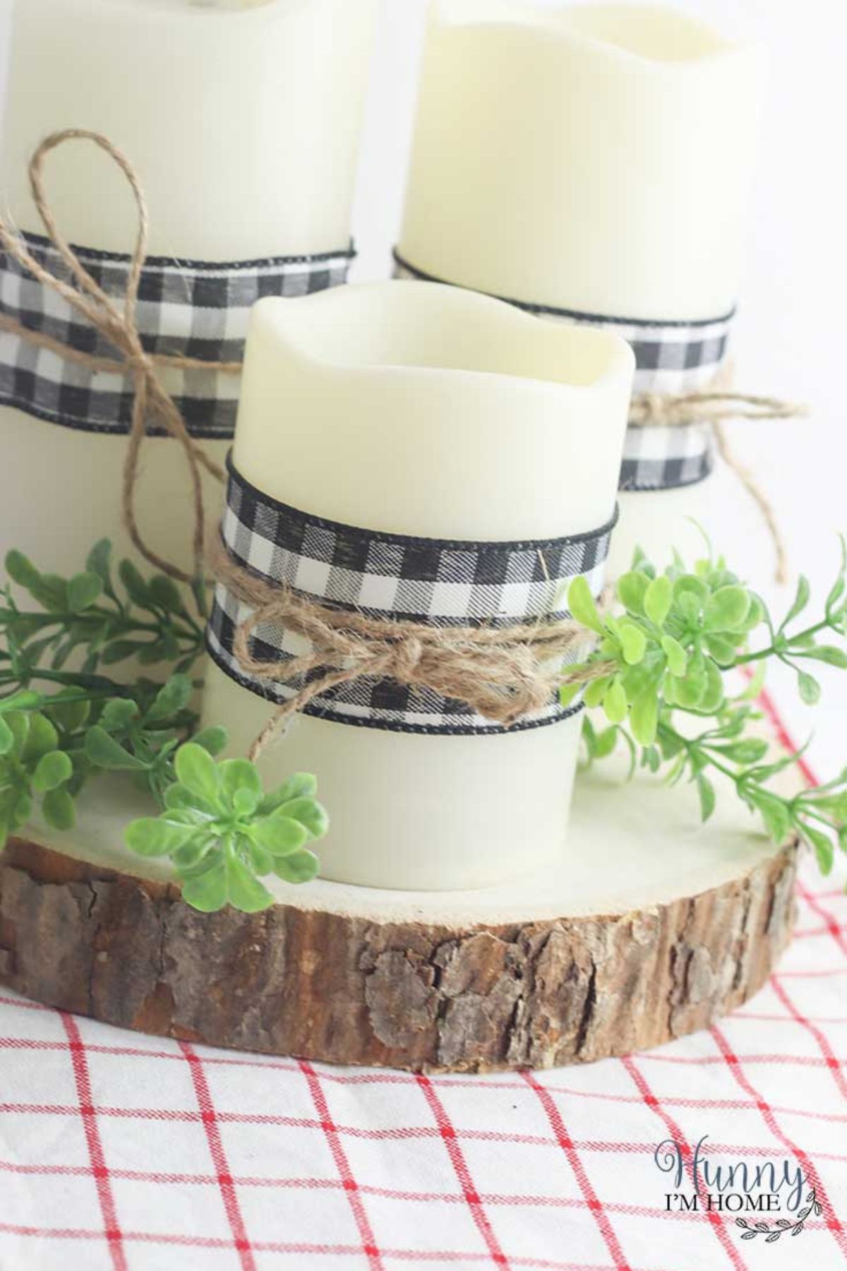 Candles wrapped in black and white checkered fabric and rustic twine.