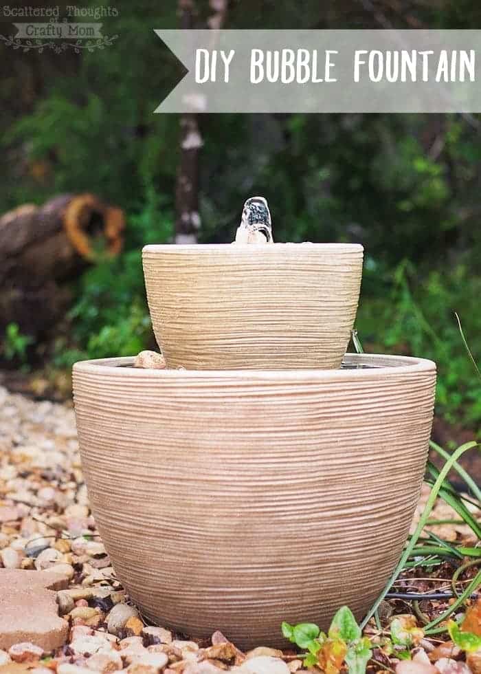 A DIY bubbler fountain outside on some stones.