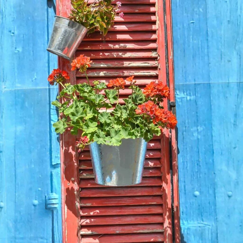 DIY woodshutter planter with tin planter pots.